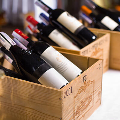 Wooden containers with bottles of wine